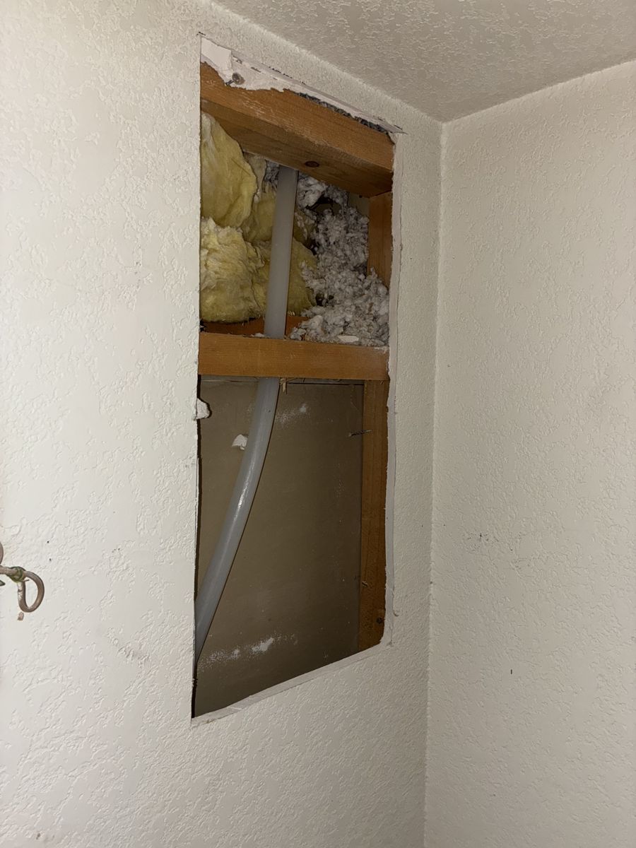 PEX supply line dropping from the attic into a wall cavity during a reroute