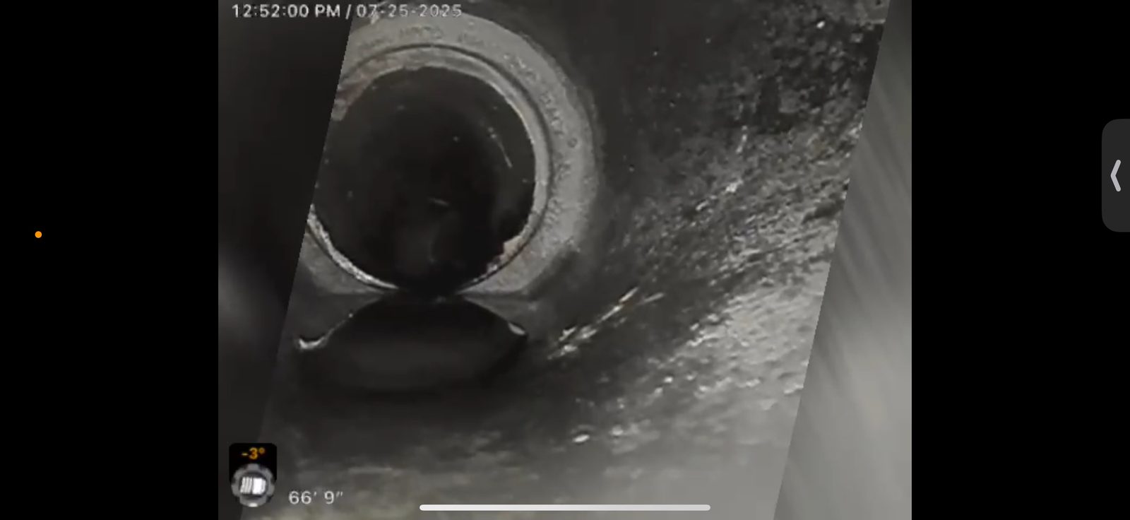 Sewer camera monitor showing a pipe joint at sixty-six feet nine inches down the line