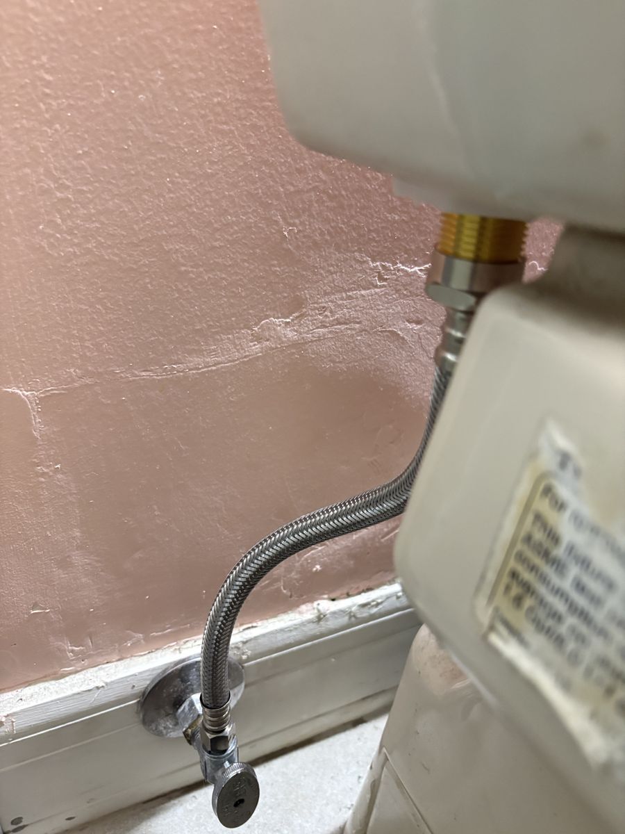 New braided stainless supply line and quarter-turn angle stop at a toilet